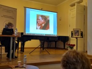 Photo of the stage and screen with Ivaskhin's portrait at a conference presentation on Ivashkin’s work
